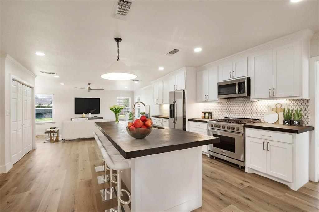 4024 Carolyn Road Fort Worth, TX 76109 - Photo 2 of 11 a kitchen with stainless steel appliances a stove sink microwave and cabinets