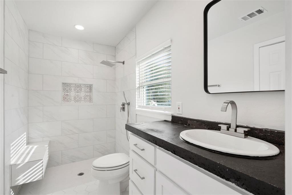 4024 Carolyn Road Fort Worth, TX 76109 - Photo 5 of 11 a bathroom with a sink a toilet and a mirror