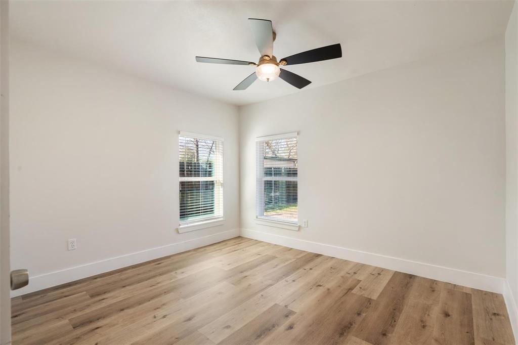 4024 Carolyn Road Fort Worth, TX 76109 - Photo 7 of 11 an empty room with wooden floor fan and windows