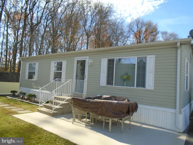 a view of house with a outdoor tub and seating space