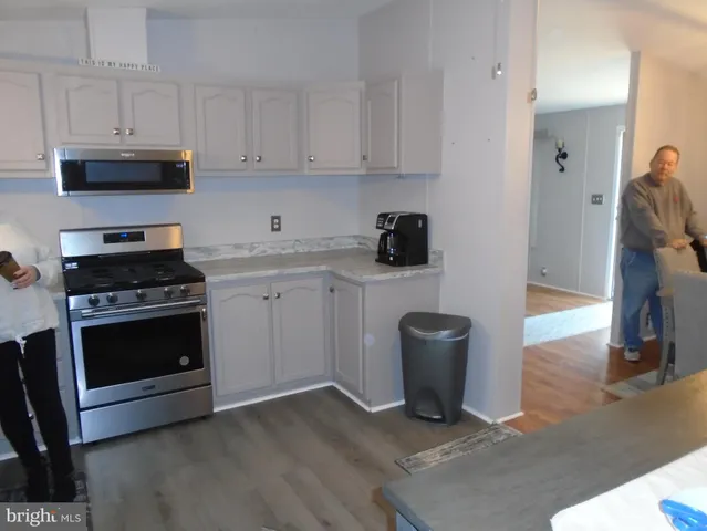 a kitchen with a stove and white cabinets