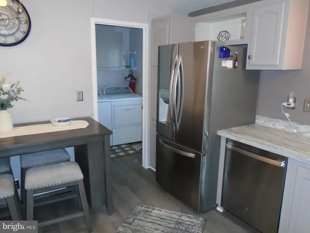 a kitchen with a refrigerator and a sink