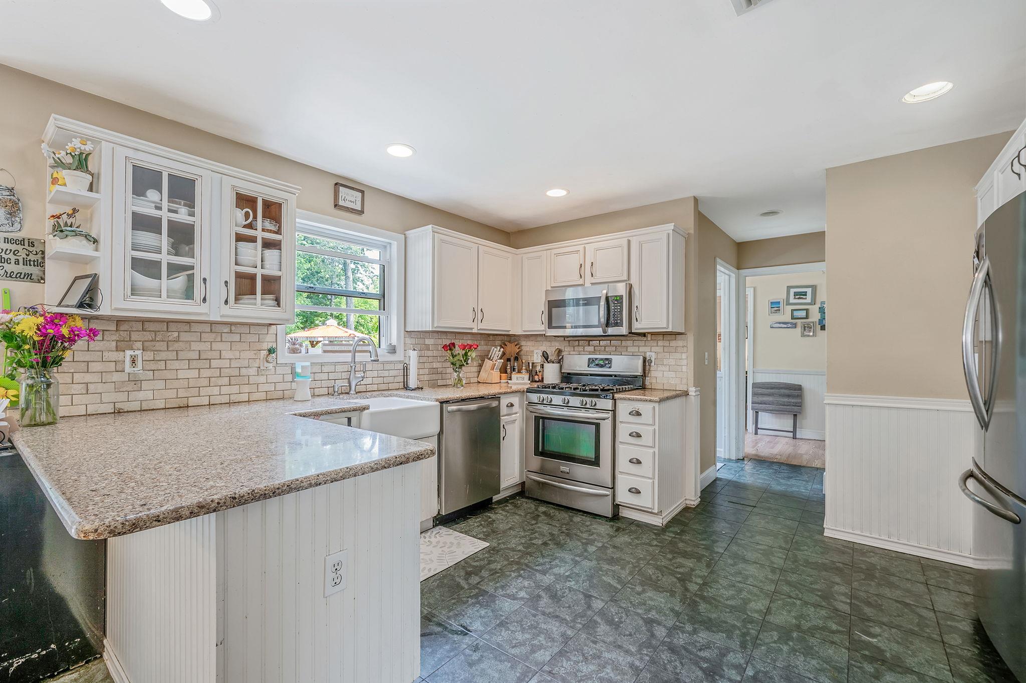 4 Ariel Court Rocky Point, NY 11778 - Photo 14 of 45 a kitchen with stainless steel appliances granite countertop a sink stove and refrigerator