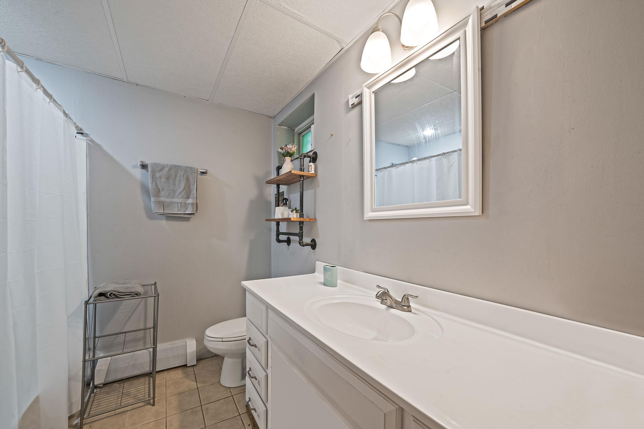 4 Ariel Court Rocky Point, NY 11778 - Photo 34 of 45 a bathroom with a sink a toilet and mirror