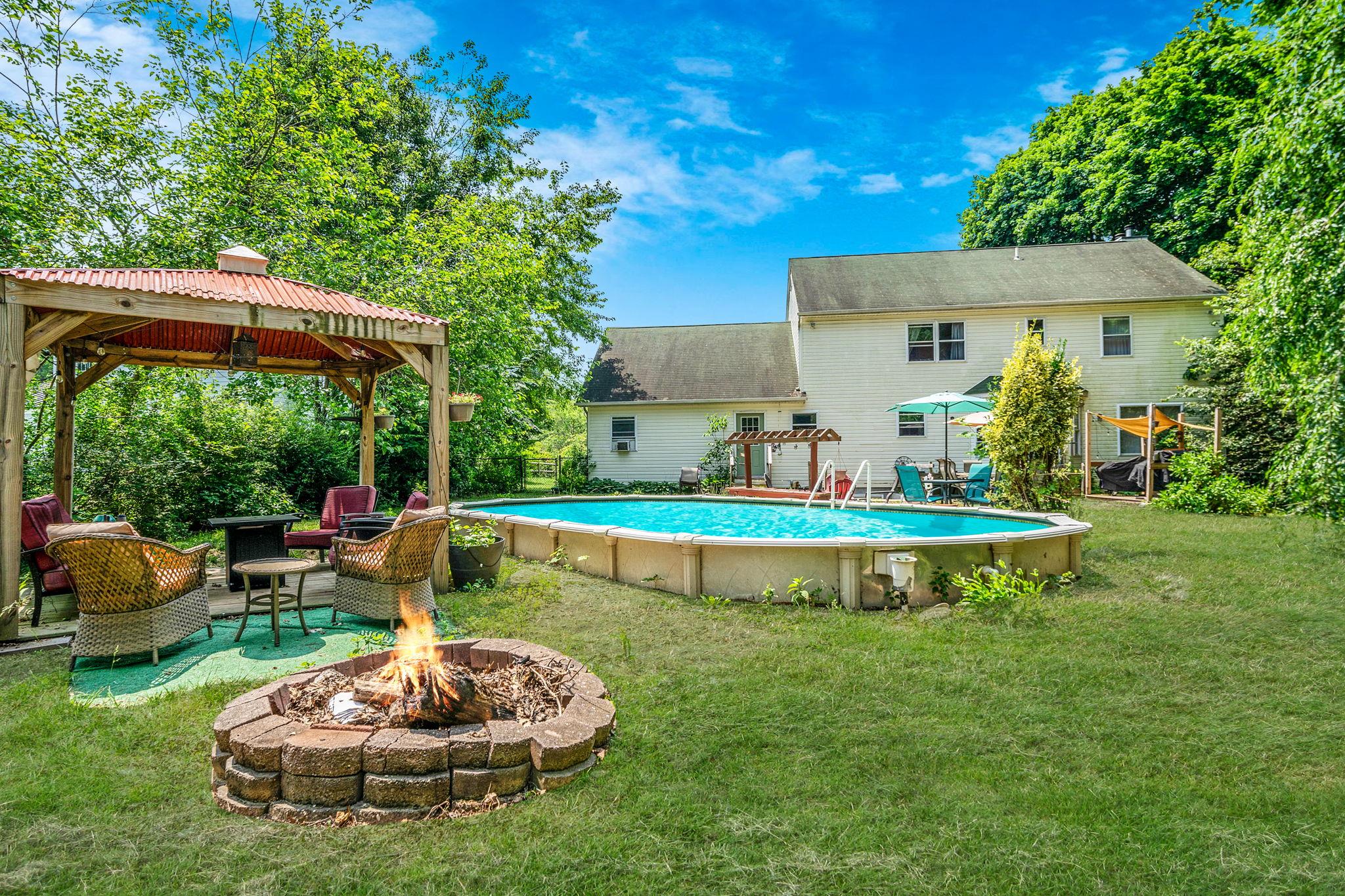 4 Ariel Court Rocky Point, NY 11778 - Photo 38 of 45 a view of a house with a yard patio and a fire pit