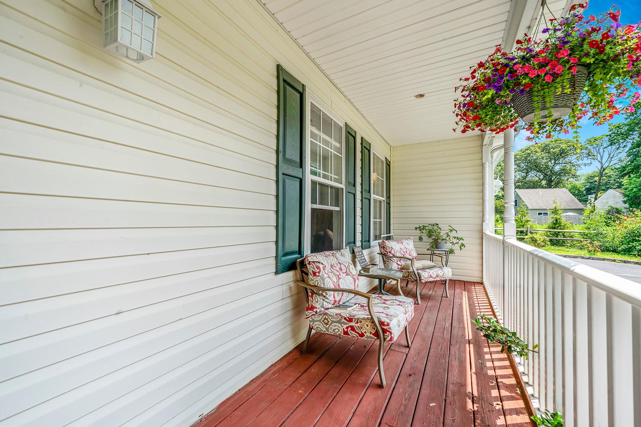 4 Ariel Court Rocky Point, NY 11778 - Photo 4 of 45 a balcony with wooden floor and bench
