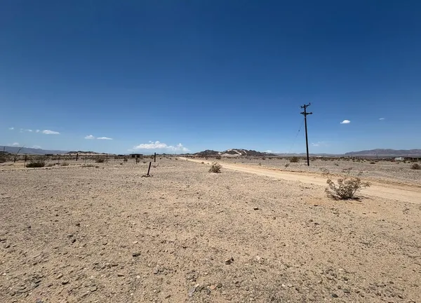 a view of a dry yard and mountain view