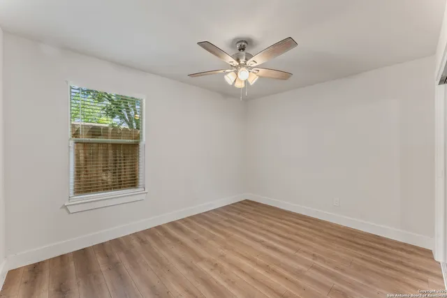 a bathroom with a granite countertop toilet a sink and a mirror