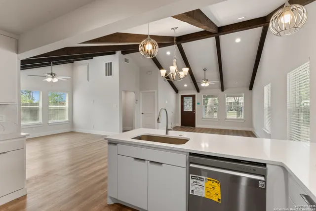 a kitchen with a sink stove and microwave