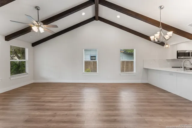 a bathroom with a granite countertop toilet sink and mirror