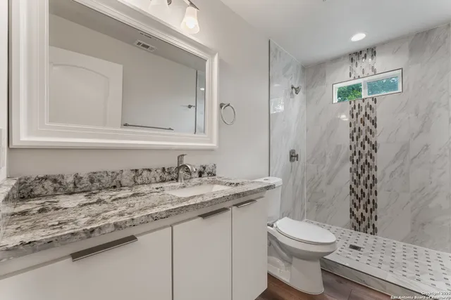 a view of a big room with wooden floor and a ceiling fan