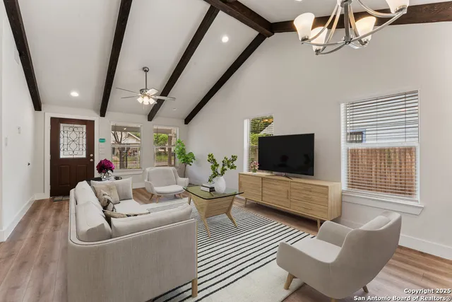 a living room with furniture and wooden floor