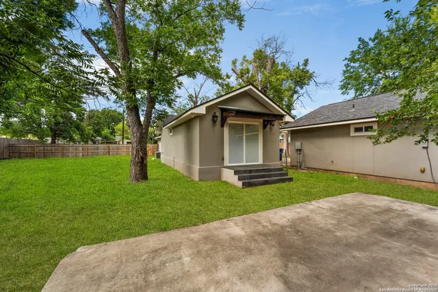 a view of yard with swimming pool and green space