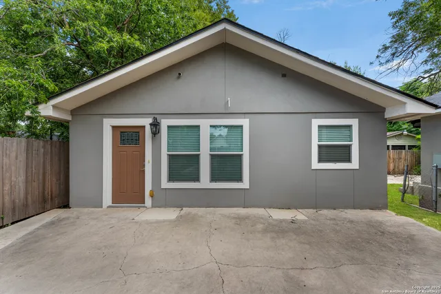 a backyard of a house with plants and trees