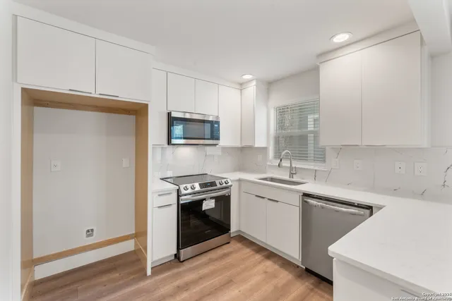 a kitchen with a sink stove and microwave