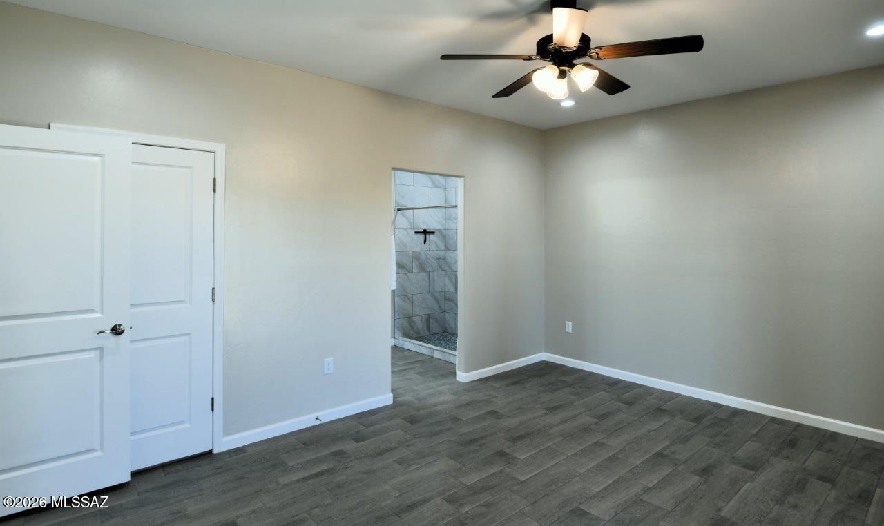 1091 North Vail View Road Vail, AZ 85641 - Photo 24 of 43 an empty room with closet and a chandelier fan