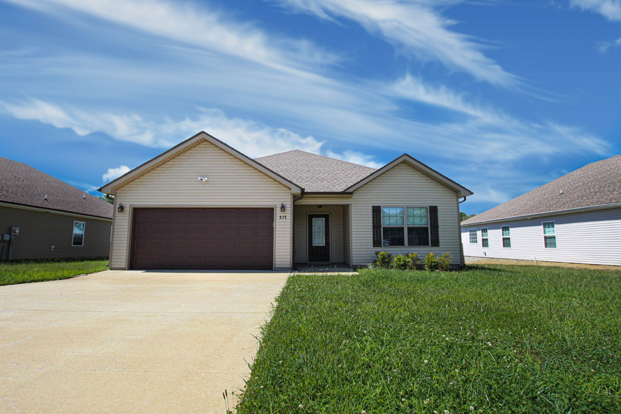 a front view of a house with a yard and garage