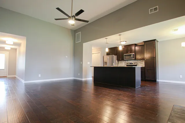 a view of kitchen with cabinets and wooden floor