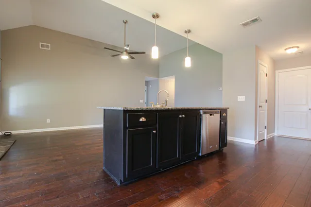 a view of a kitchen counter space and wooden floor
