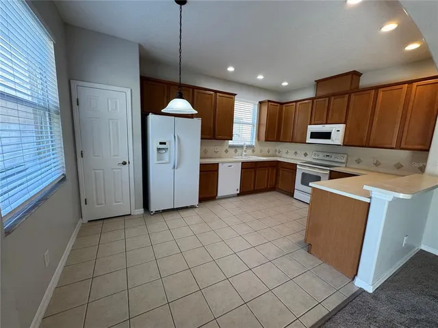 a kitchen with cabinets and window
