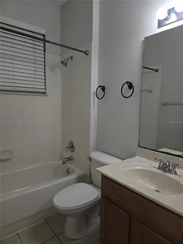 a bathroom with a sink toilet vanity and shower