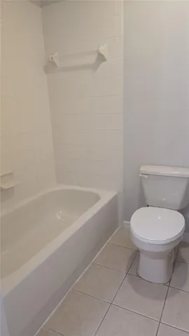 a bathroom with a toilet and a bathtub