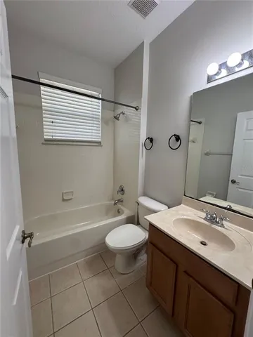 a bathroom with a sink a toilet a mirror and shower