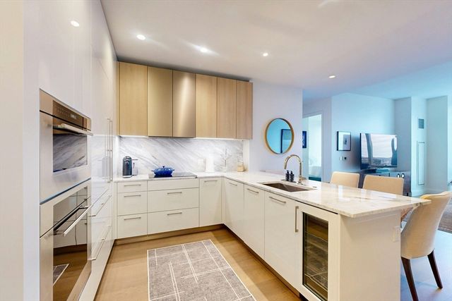 a kitchen with a sink appliances and cabinets