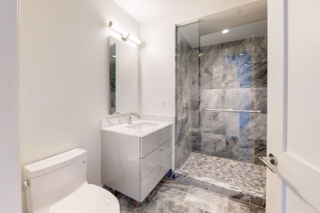 a bathroom with a shower sink and mirror