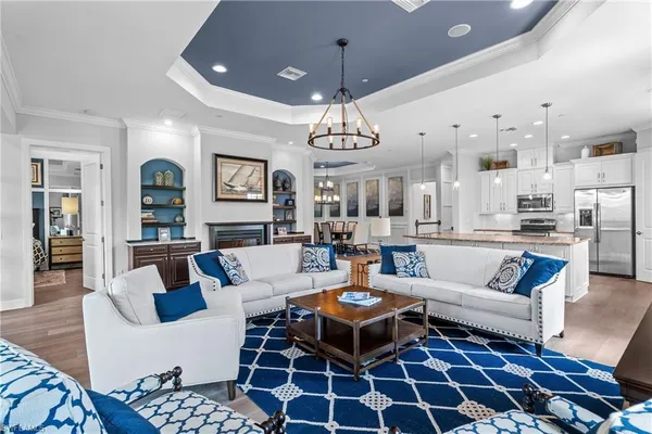 a living room with a dining table and a rug