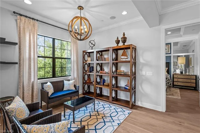 a view of a livingroom with furniture and a bookshelf