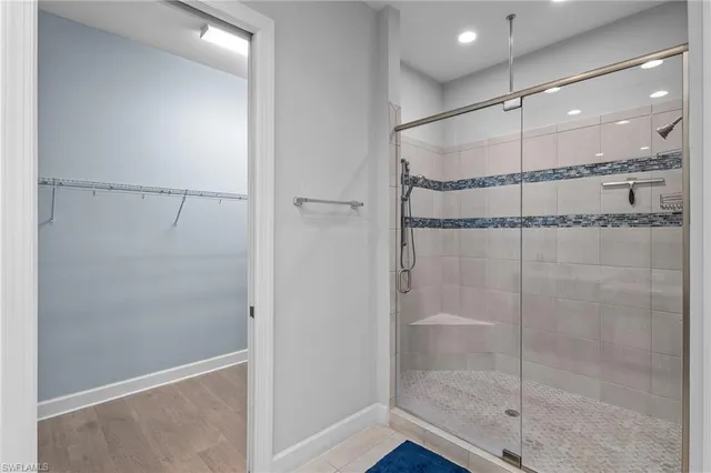 a bathroom with a glass shower door