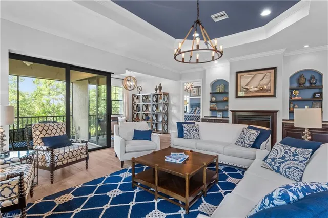 a living room with fireplace furniture and a large window