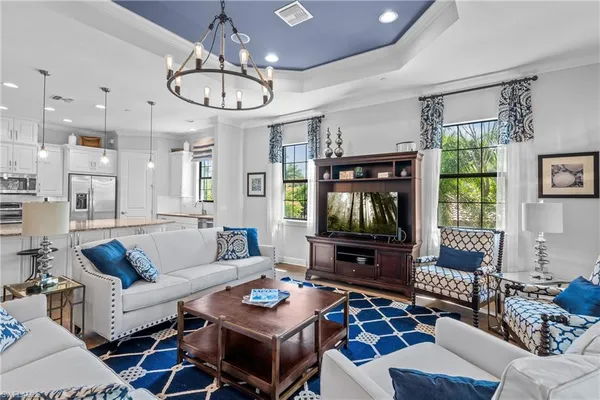 a living room with furniture a large window and a flat screen tv