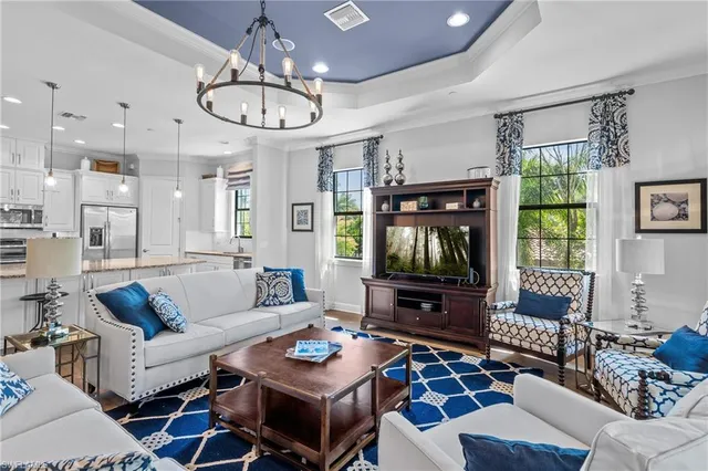 a living room with furniture a large window and a flat screen tv