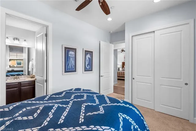 a bedroom with a bed and painting on the wall