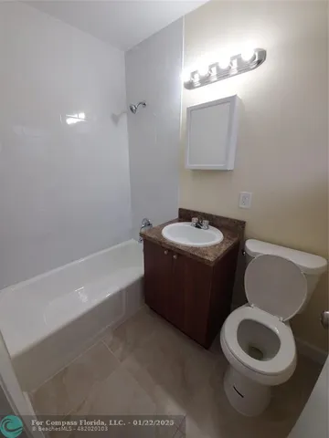 a bathroom with a toilet a sink and bathtub
