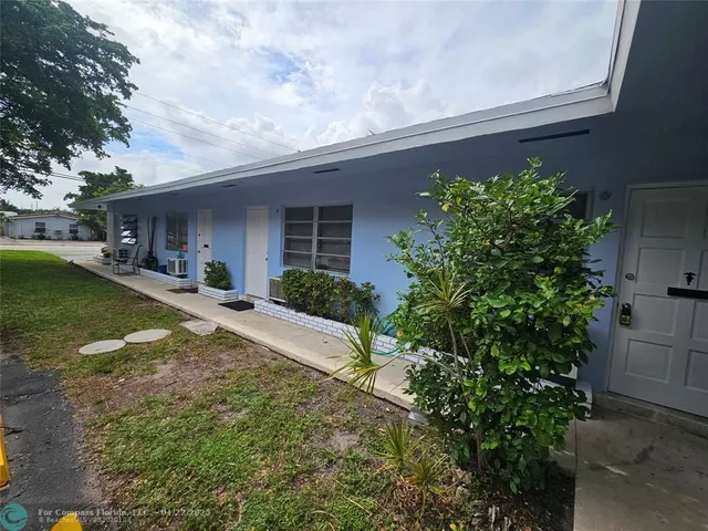 a view of a house with a yard and plants