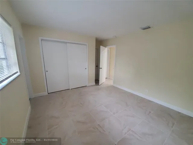 a view of an empty room and a window