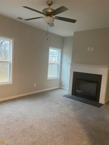 a view of empty room with a fireplace