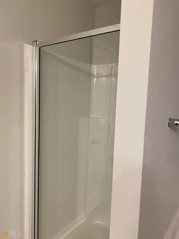 a bathroom with a glass shower door