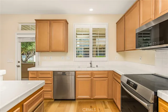 a kitchen with a sink stove top oven and microwave