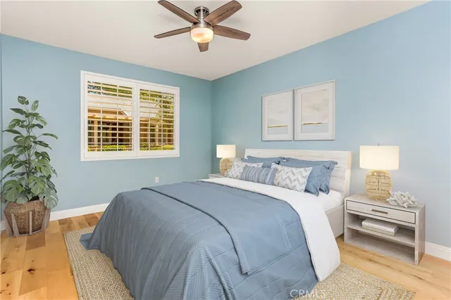 a bedroom with a bed and a potted plant