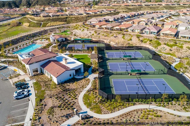 a view of a garden with a bench in front of house