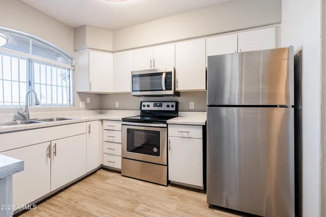 a kitchen with a refrigerator sink and microwave