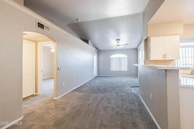 a view of hallway with livingroom and windows