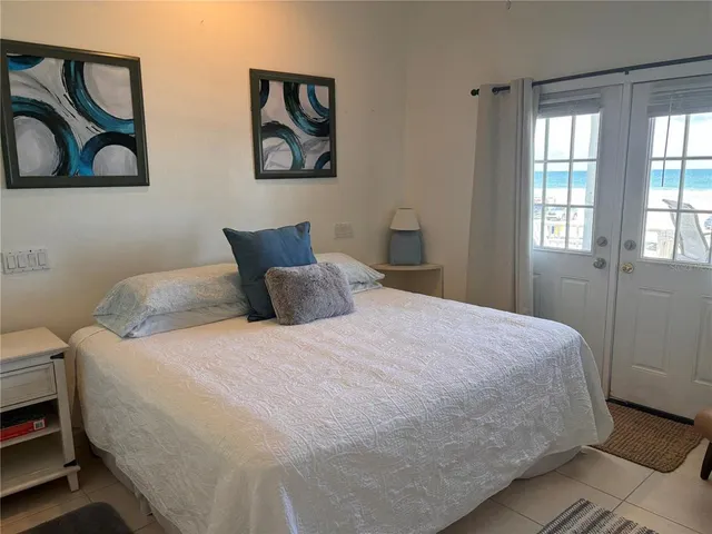 a bedroom with a bed and painting on the wall