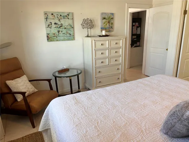 a bedroom with a bed and chair