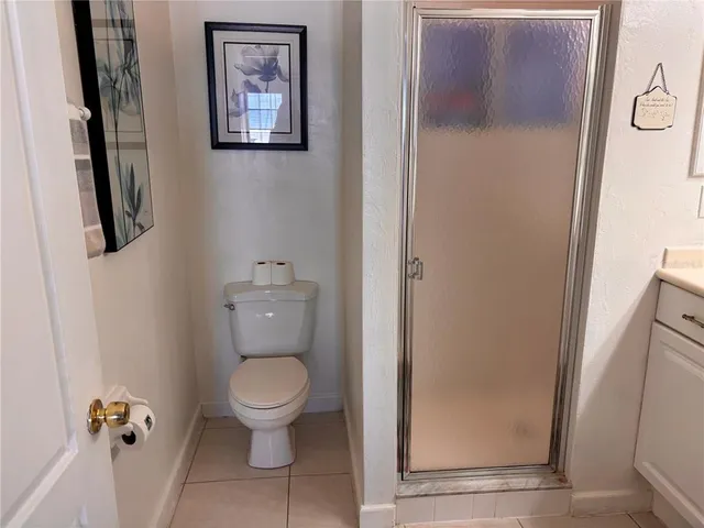a white toilet sitting next to a small bathroom