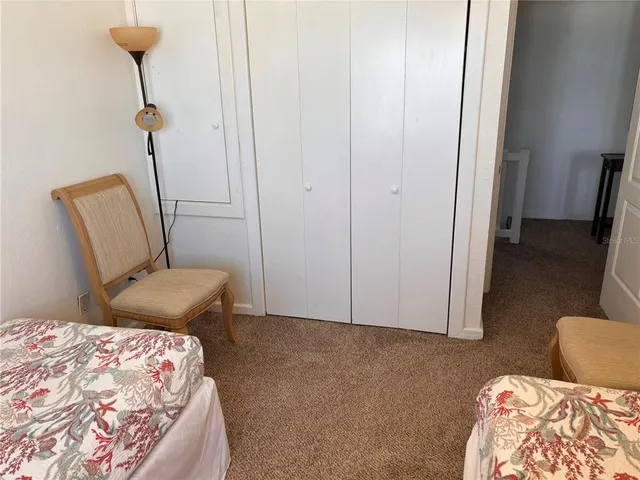 a bedroom with a bed and a chair